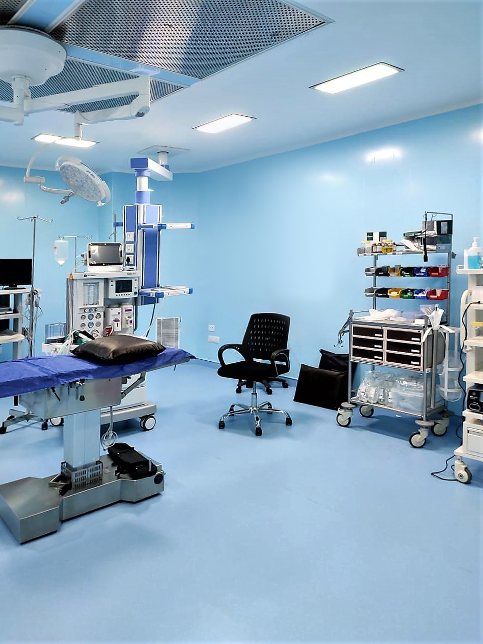 Hospital operating room with light blue antimicrobial wall panels, surgical equipment, and medical wall panels for sterile environment compliance